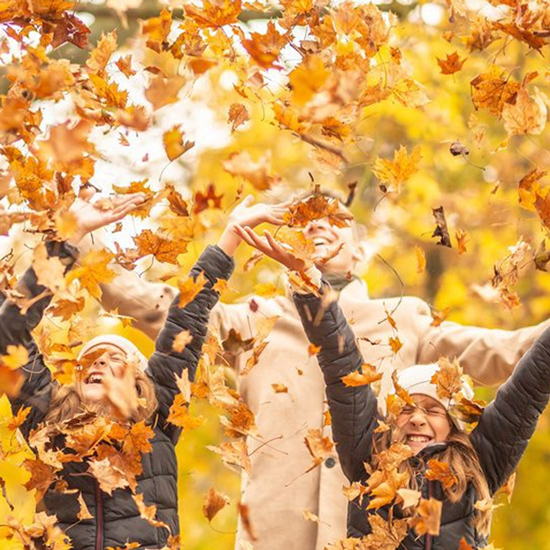 Familie werfen Herbstblätter hoch